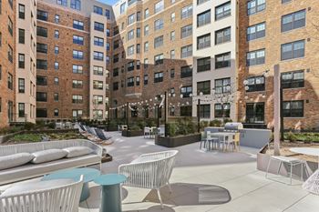 Landscaped courtyard with grills and lounge areas